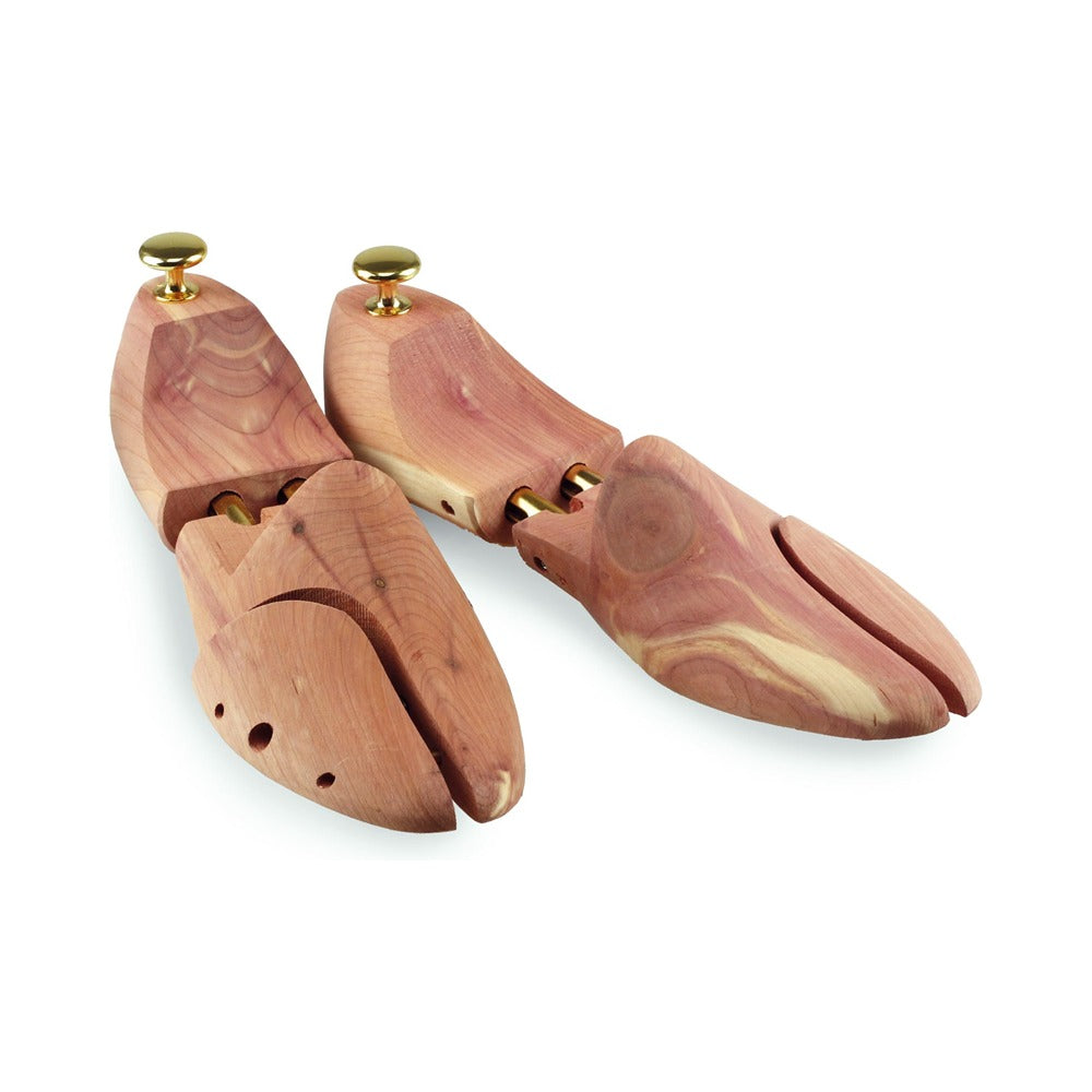 A pair of cedar shoe trees with brass knobs and twin tube springs.