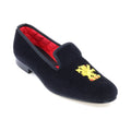 The Albert slipper in blue velvet, a gold lion rampant embroidered on the vamp.