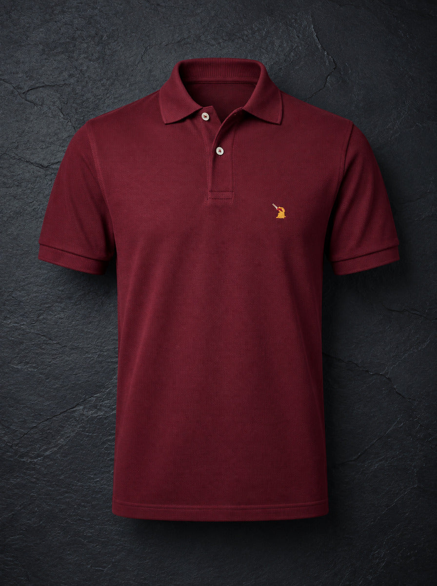 The St John Parker polo in burgundy piqué, the embroidered bird at the left chest.