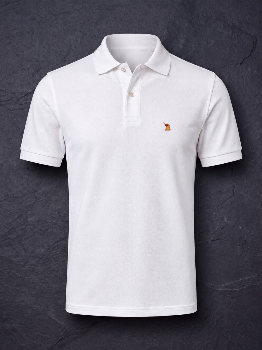 The St John Parker polo in white piqué on dark slate, the embroidered bird at the left chest.