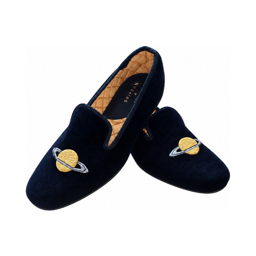 The Albert slipper in black velvet, a gold planet ringed in silver embroidered on the vamp, gold quilted lining.