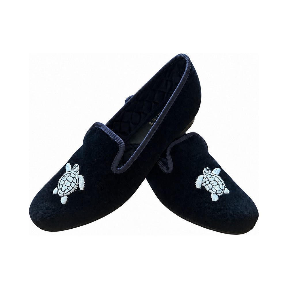 The Albert slipper in black velvet, a silver turtle embroidered on the vamp, black quilted lining.